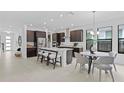 Modern kitchen with stainless steel appliances, large island, and breakfast nook, creating a modern design at 741 58Th Ne Ave, St Petersburg, FL 33703