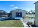 Spacious detached garage with an open door, providing ample storage and workspace at 11945 Carmen Ave, Dade City, FL 33525