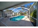 Beautiful screened-in pool with a clear blue water, ready for relaxation and recreation at 11945 Carmen Ave, Dade City, FL 33525