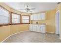 Small kitchen with white cabinets and tile floor at 1593 76Th N Ave, St Petersburg, FL 33702