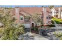 Aerial view of a tan townhouse with a garage and landscaping at 17996 Villa Creek Dr # 17996, Tampa, FL 33647