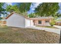 Brick house with a white garage door and a well-maintained lawn at 503 Avocado Cir, Brandon, FL 33510