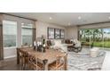 Open living and dining area with a large sectional sofa and sliding glass doors at 721 Sky Shade Dr, Apollo Beach, FL 33572