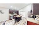 Modern kitchen featuring wood floors, updated appliances, and a center island with seating at 10543 Opus Dr, Riverview, FL 33579