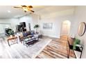 Spacious living room featuring wood floors, modern furniture, and ample natural light at 10543 Opus Dr, Riverview, FL 33579