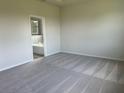 This spacious bedroom has neutral carpet and paint, and an ensuite bathroom with a tub at 16026 10Th E Ave, Bradenton, FL 34212