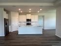 Spacious kitchen with an island, stainless steel appliances, and a white subway tile backsplash at 16026 10Th E Ave, Bradenton, FL 34212