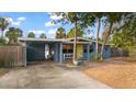 Charming light blue home with carport and landscaped yard at 3863 Belle Vista E Dr, St Pete Beach, FL 33706