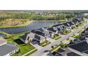A beautiful neighborhood featuring a serene lake view, neatly lined streets, and well-maintained landscaping at 3901 Tour Trce, Land O Lakes, FL 34638