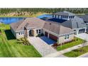 A well-manicured lawn and brick driveway lead to this beautiful single-Gathering home near a lake at 3901 Tour Trce, Land O Lakes, FL 34638