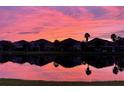 Beautiful sunset reflected in lake with homes in background at 7001 Interbay Blvd # 273, Tampa, FL 33616