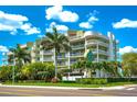 Exterior view of a modern condo building with landscaping at 11605 Gulf Blvd # 507, Treasure Island, FL 33706