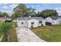 Newly renovated house with stone exterior, landscaped yard, and driveway at 205 Kingston S St, St Petersburg, FL 33711