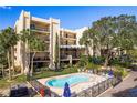 Condo complex with a refreshing blue pool and lounge chairs at 206 Tarpon Pt, Tarpon Springs, FL 34689