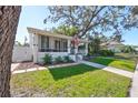 Quaint bungalow with a screened porch and established landscaping at 218 15Th N Ave, St Petersburg, FL 33704