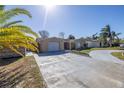 Single-story house with a two car garage and a long driveway at 7430 Buchanan Dr, Port Richey, FL 34668