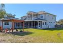 Large backyard with a pergola, screened porch, and grassy area at 11305 Sweet Bay Ct, Riverview, FL 33569