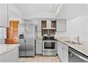 Modern kitchen featuring stainless steel appliances and granite countertops at 13250 Ridge Rd # 2-1, Largo, FL 33778