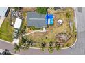 This overhead shot features a home with a gray roof and front yard, highlighting the neighborhood's serene street layout at 8474 Tobay N Rd, St Petersburg, FL 33702