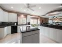 Modern kitchen with white cabinets, granite countertops, and island at 921 Osceola Rd, Belleair, FL 33756