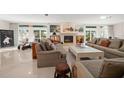 Spacious living room featuring comfortable seating, a fireplace, and large windows at 921 Osceola Rd, Belleair, FL 33756
