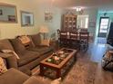 Bright living room with dining area, featuring hardwood floors at 9218 Mission Oaks Blvd # E, Seminole, FL 33776