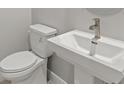 Close-up view of a half-bath with white fixtures and modern faucet at 18424 Vista Park Ter, Venice, FL 34293