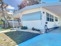White single-wide manufactured home with carport and landscaped yard at 2331 Belleair Rd # 116, Clearwater, FL 33764