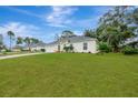 Landscaped yard and a charming one-story house exterior at 2310 Holston Ave, Spring Hill, FL 34608