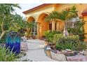 Landscaped entryway with tropical plants, stonework, and a water feature at 3921 Mimosa Pl, Palm Harbor, FL 34685