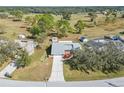 House with a large backyard and a view of the golf course at 5592 Fairway Dr, Ridge Manor, FL 33523