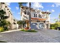 Elegant two-story home with a two-car garage, featuring a well-manicured lawn and lovely tropical landscaping at 102 S Moody Ave # 3, Tampa, FL 33609