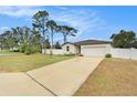 House exterior featuring a two-car garage and landscaped yard at 11209 Roman St, Spring Hill, FL 34609