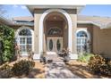 Elegant entryway with arched doorway and double doors at 1304 Steeple Hill Ct, Brandon, FL 33511