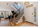 Bright entryway with staircase, piano, and hardwood floors at 1688 Watermark Ne Cir # 1688, St Petersburg, FL 33702