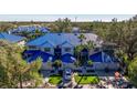 Beautiful condo with striking blue roof and well-manicured landscaping, including palm trees, in an idyllic neighborhood at 1688 Watermark Ne Cir # 1688, St Petersburg, FL 33702