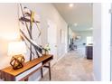 Bright and spacious entryway with a modern console table at 174 Green Oak Park, Rotonda West, FL 33947