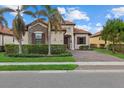 Well-maintained home with a welcoming front porch and palm trees at 23503 Waverly Cir, Venice, FL 34293