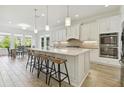 Modern kitchen with large island, stainless steel appliances, and breakfast bar at 4383 Ortona Ln, Wesley Chapel, FL 33543