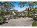 Single-story home with gravel driveway and lush landscaping at 5021 24Th S Ave, Gulfport, FL 33707