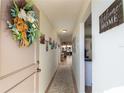 Inviting entryway with decorative wreath and view to living area at 5501 80Th N St # 214, St Petersburg, FL 33709