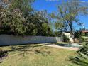 Inviting backyard oasis featuring a pool, grassy area, and privacy fence at 632 Superior Ave, Tampa, FL 33606