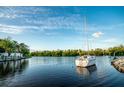 Sailboat in a calm canal with lush vegetation at 6530 Senegal Palm Way, Apollo Beach, FL 33572