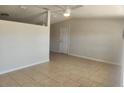 Bright living room features neutral paint, new ceiling fan and tile flooring throughout at 11608 Zimmerman Rd, Port Richey, FL 34668