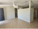 The living room offers a neutral palette, tile flooring and a ceiling fan at 11608 Zimmerman Rd, Port Richey, FL 34668