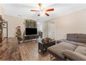 Living room with sectional sofa, TV, and wood floors at 1742 31St S St, St Petersburg, FL 33712