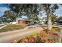 Brick house with landscaped yard and driveway at 1922 Sheffield Ct, Oldsmar, FL 34677