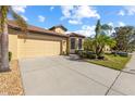 Front view of house with driveway and landscaping at 309 Mystic Falls Dr, Apollo Beach, FL 33572