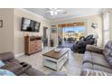 Spacious living room with tiled floors, comfy furniture and access to a lanai at 309 Mystic Falls Dr, Apollo Beach, FL 33572