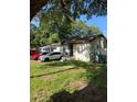 Cozy home situated on a large lot with a grassy yard at 8218 N 18Th St, Tampa, FL 33604